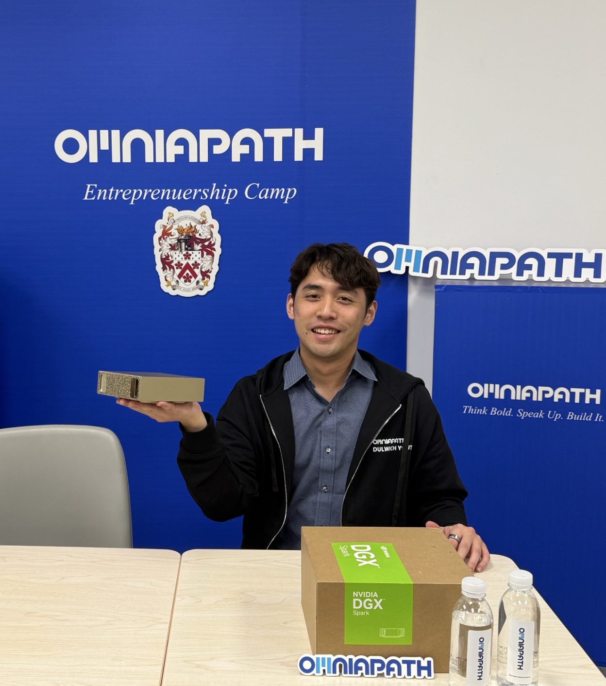 OMNIAPATH founder Barry Li holding the NVIDIA DGX Spark at the Entrepreneurship Camp
